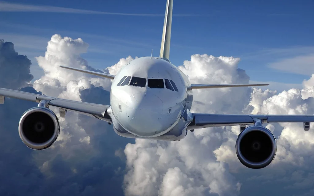 Avión comercial volando a gran altitud rodeado de nubes